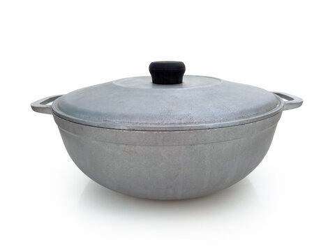 Front view of vintage aluminum saucepan with lid isolated. Old gray oval casserole on white background. Kitchen and restaurant utensils.