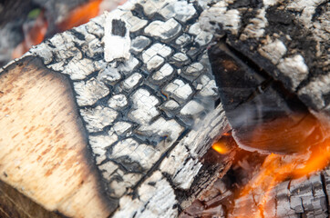 Burning firewood in the grill, bright coals and flames