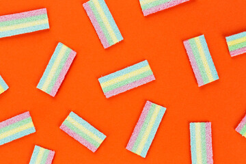 Licorice Candy. Sweet gummy sticks with different flavor, on orange background.