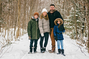 Portrait of a four Family On forest Winter season