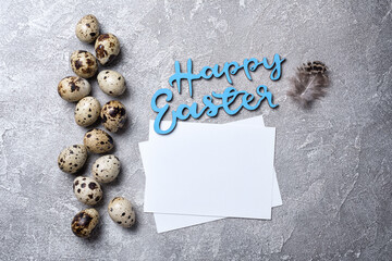 Small quail eggs for Easter day and mock-up of blank white card