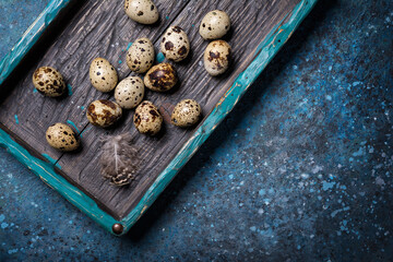 Small quail eggs in bright vintage wooden box