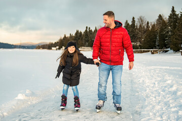 Happy family on ice skating on winter season lake