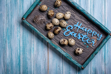 Small quail eggs for Easter day in bright vintage wooden box