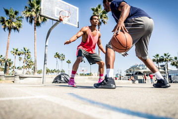 Young players playing basketball at the court in venice beach, California. Professional street...