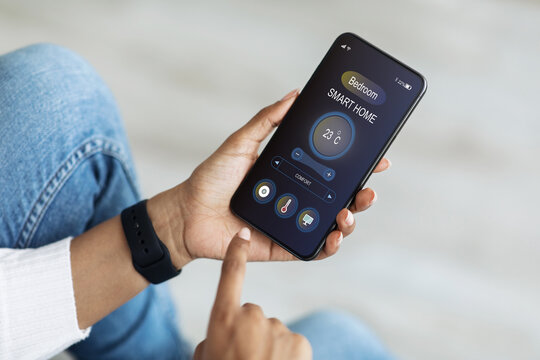African american woman setting temperature in bedroom