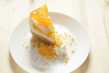  A piece of cake on a white ceramic dish.