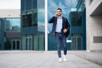 Young middle-eastern entrepreneur going home, talking on phone