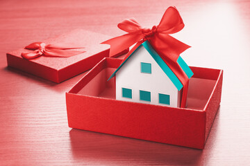 House model with gift ribbon in a gift box