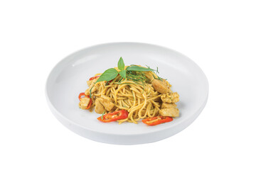 Green curry spaghetti with chicken in a white plate placed