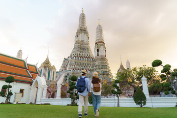 Asian couple happy tourists to travel on they holidays and holding in Wat Arun Temple in Bangkok, Thailand © Prasit Rodphan