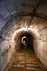 Fototapeta na wymiar Illuminated tunnel or underpass under the Kalaja e Gjirokastres Castle of Gjirokastra in Albania