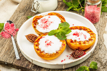 Grilled peach with yogurt, mint, and sweet pink sugar. Useful breakfast concept, healthy food