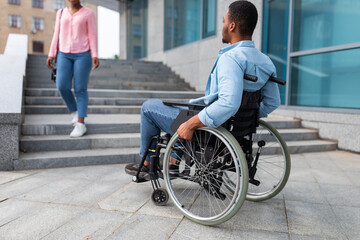 Black disabled guy suffering from lack of wheelchair friendly facilities, cannot enter building...