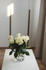 White rose bouquet in a cozy home interior. Floral spring background