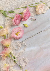 Pink flowers on marble table top view