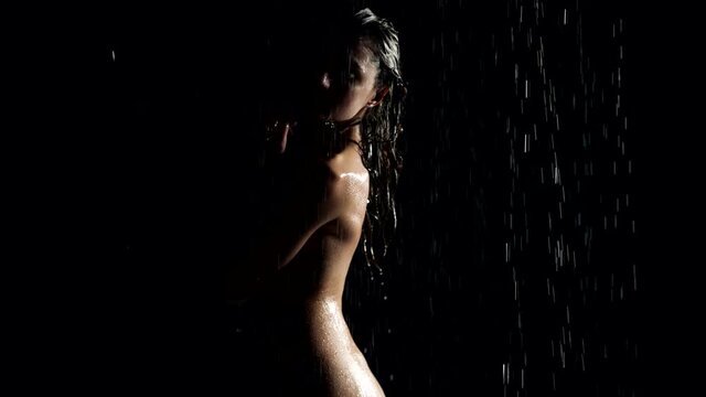 sexy naked woman in shower in darkness, graceful silhouette of lady