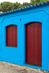 Blue Colored House with red Door and Window. City of Porto Seguro. Bahia.