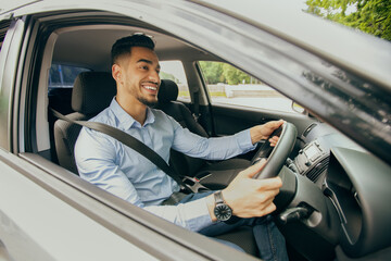 Fototapeta na wymiar Positive middle-eastern guy going to office, driving car