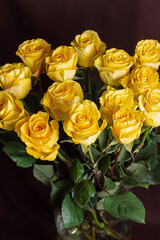 Freshly cut yellow roses on dark background. Beautiful bouquet for Woman's Day