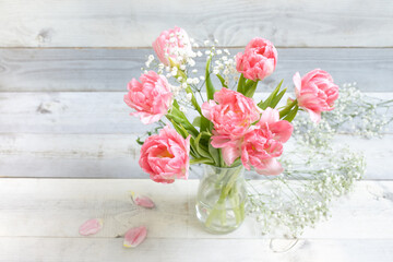 Beautiful fresh pink tulips in vase on background of white boards. Concept of spring bouquet, March 8, women's day, springtime, festive mood, mother's day, holiday, happy birthday. Nobody. Horizontal.