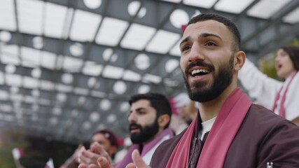 Muslim man sincerely supporting team during football game