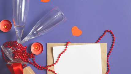 Valentine's day. two glasses, envelope with sheet blank, hearts, candles on Very Peri, Trendy violet color background. Romantic dinner couple concept. flat lay. top view