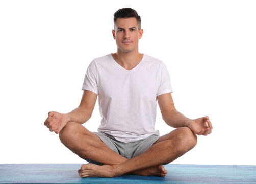 Handsome Man Meditating On Yoga Mat Against White Background