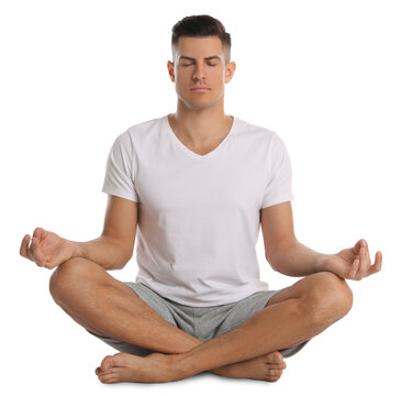Handsome Man Meditating On White Background. Harmony And Zen