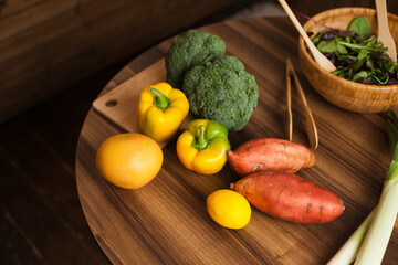 Vegetables and eco wooden bamboo bowl on the kitchen table for cooking homemade healthy dinner or lunch. Still life with sweet potato, broccoli, lettuce and other fruit and vegetables