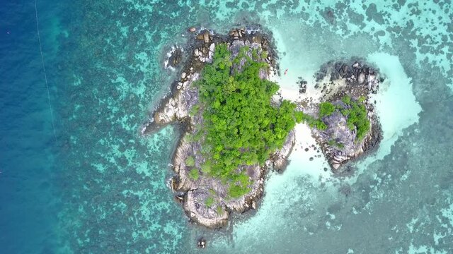 Stunning summer landscape. Aerial view of turquoise Andaman sea with reef and small island at Koh Lipe or Lipe island, Satun, Southern Thailand. 4K drone video