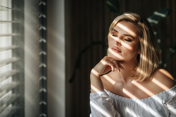 Relax at home pretty young woman deep in thought near window