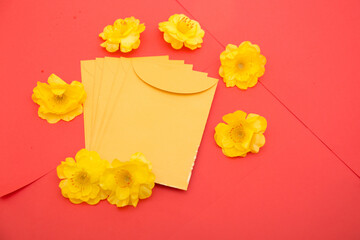 Tet holiday , lunar new year concept with flower and yellow lucky envelopes on red 