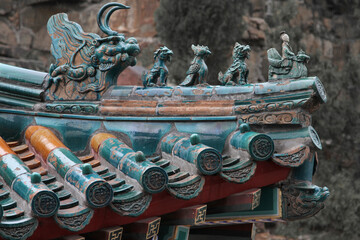 Glazed china jade roof tiles in a historic temple with a dragon © Paulo