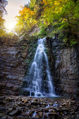 Fototapeta na wymiar Beautiful waterfall among the canyon in the Carpathian mountains. Manyavsky waterfall.