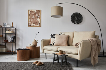 Creative composition of modern living room interior with mock up poster frame, beige sofa, side...