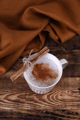 Coffee with cinnamon on a wooden table