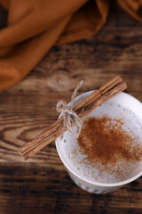 Coffee with cinnamon on a wooden table