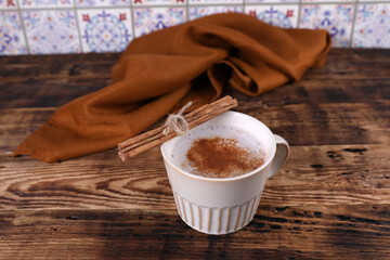 Coffee with cinnamon on a wooden table