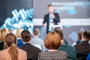 Audience watching presentation during business seminar