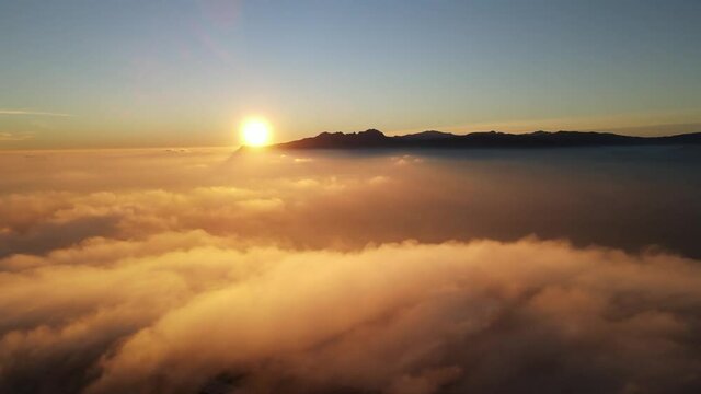 Fooggy sunset in Cumbre del sol. The fog hides the horizon and de coastline. Drone views from Benitachell, Moraira, Calpe and J&aacute;vea, in Alicante, Spain
