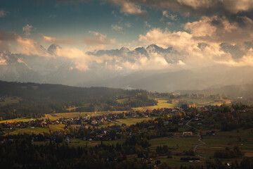 Tatra Mountains seen on a cloudy day. The shining light between the clouds creates an interesting atmosphere in the photo.