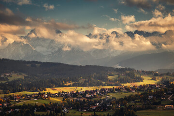 Tatra Mountains seen on a cloudy day. The shining light between the clouds creates an interesting atmosphere in the photo.