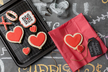Valentine Cookies Decorated with Red and White Icing on a Chalkboard Background