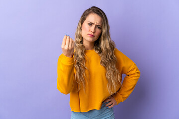 Young Brazilian woman isolated on purple background making Italian gesture