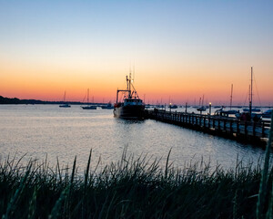Sunset in the harbor. Pier at night.