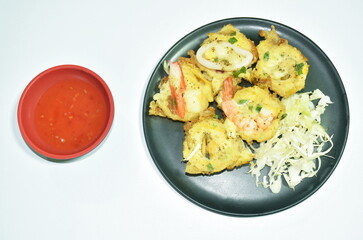 Thai sweetmeat grilled Mortar-toasted pastry seafood  coconut cream hotcake called Kanom Krok dipping chili sauce on plate