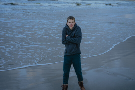 frozen teenager stands on the seashore
