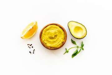 Green guacamole avocado dip in bowl, top view