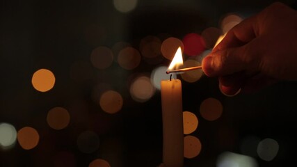 The candle light up over the bokeh window glass in the dark.